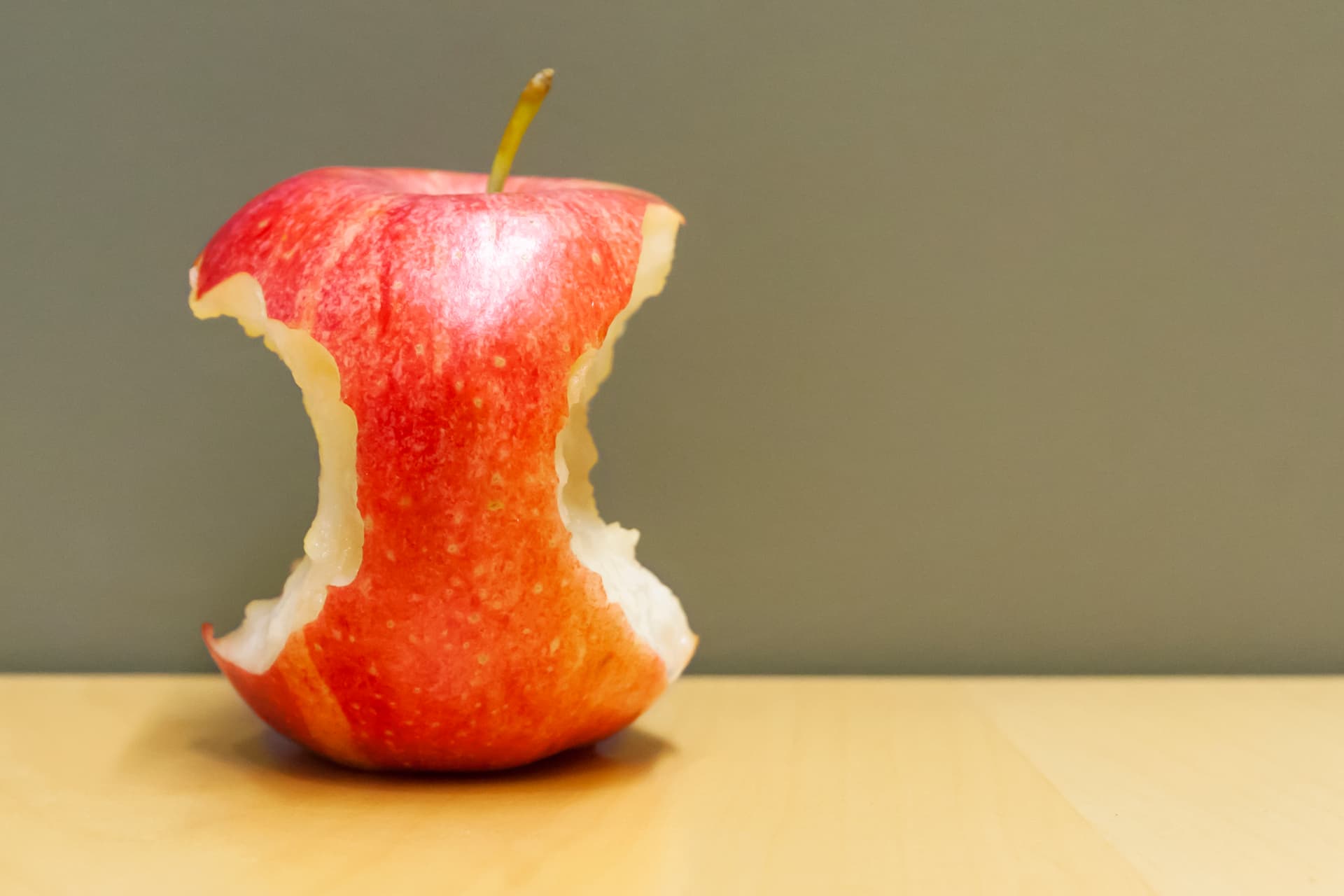 photo of red apple with two bites