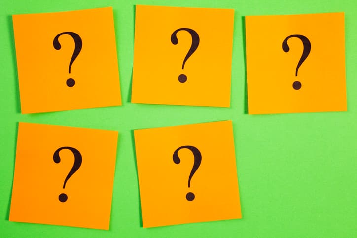 five question marks on sticky notes