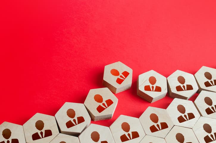 Graphic of wood chips with the outlines of business people.