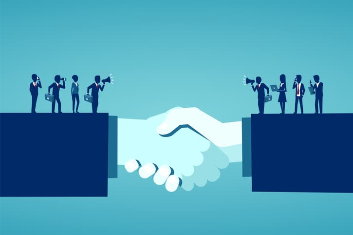 An illustration of two businesspeople shaking hands. On top of their arms are smaller businesspeople communicating with each other