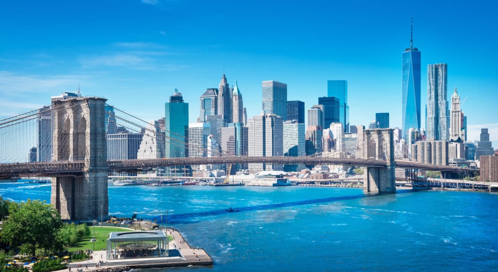 Brooklyn Bridge with Manhattan in background and blue sky