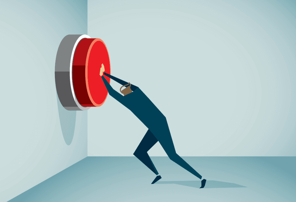 image of man pushing giant red stop button on wall