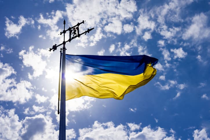 The Ukrainian flag against a bright sky