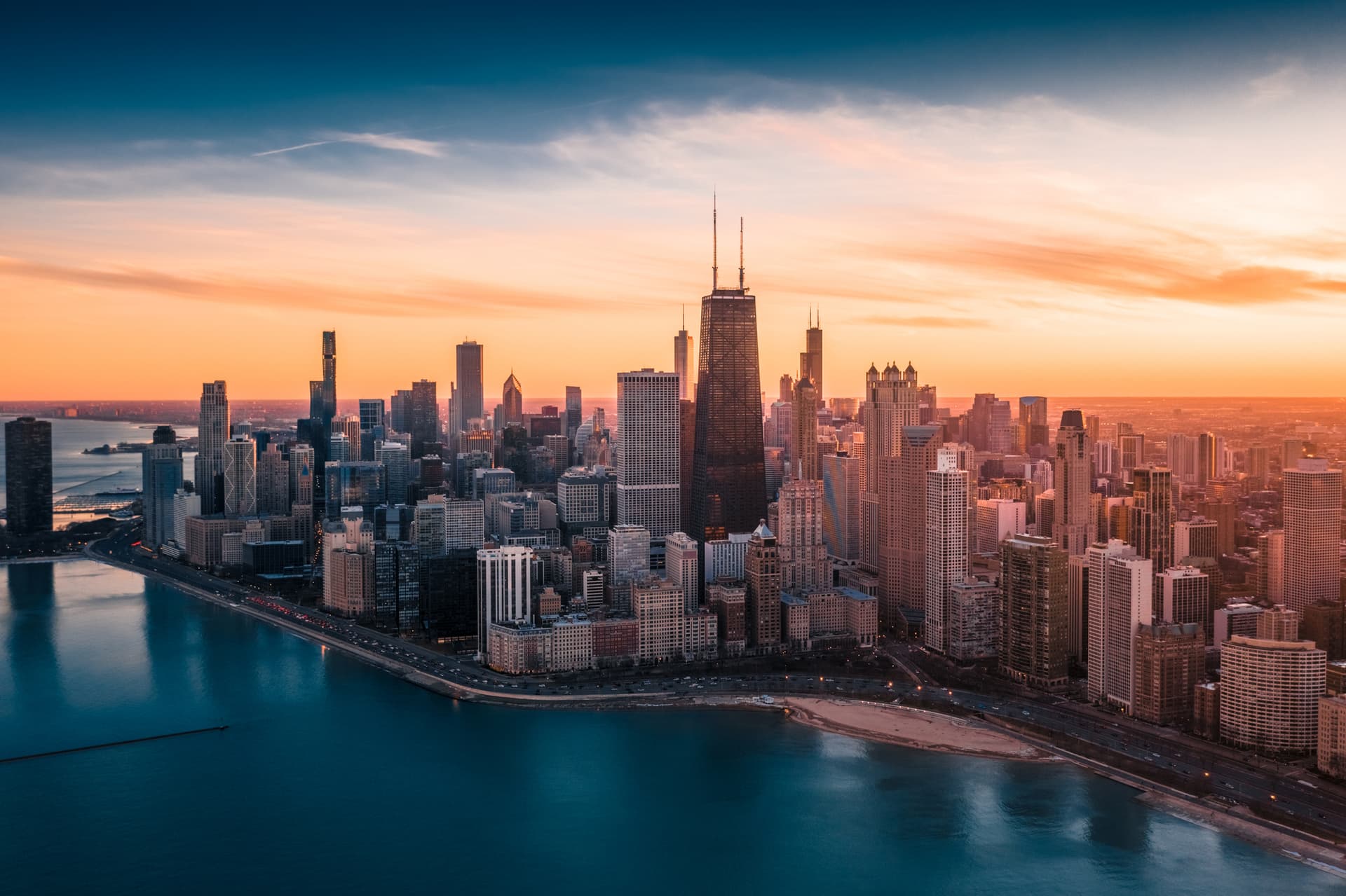 Dramatic sunset over Downtown Chicago, with the Willis Tower prominent in the centre
