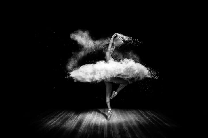 Tutu from powder. Beautiful ballet dancer, dancing with powder on stage
