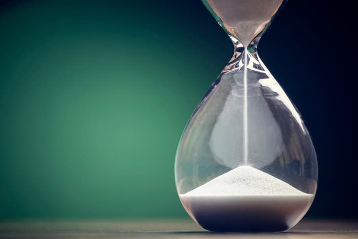 An hourglass with the sand beginning to run out