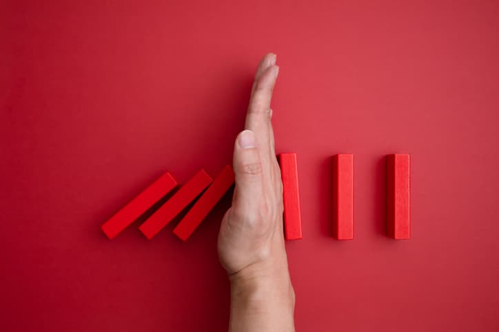 hand through red dominos