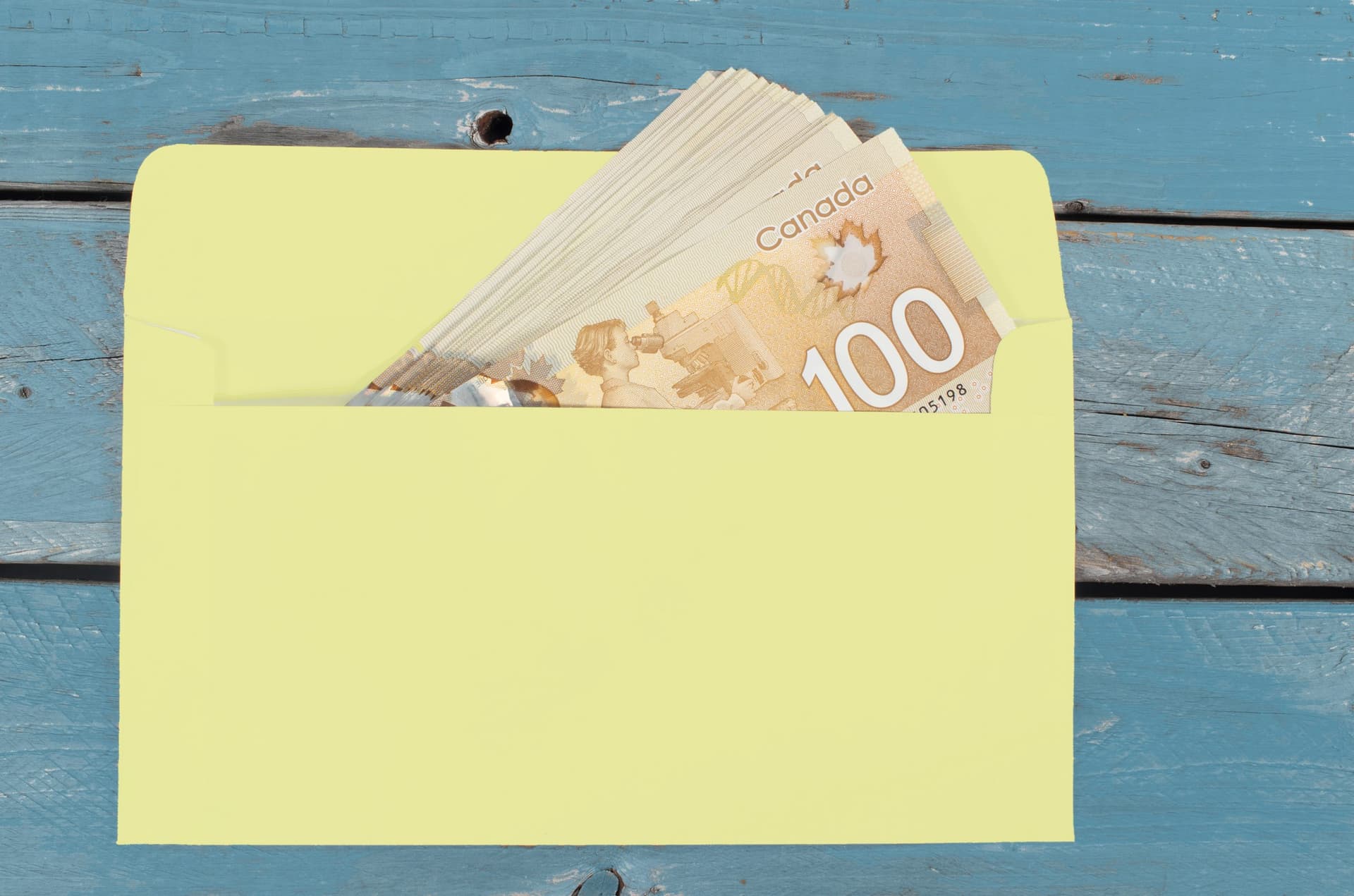 Canadian dollars in green envelope
