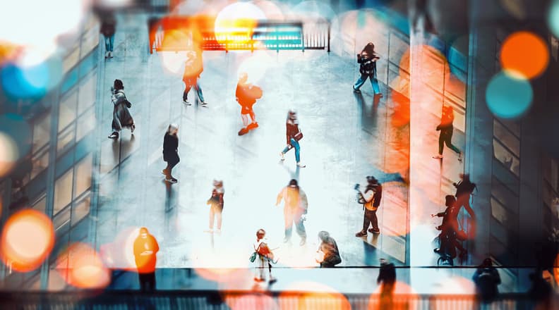 Crowds of people walking through a public space