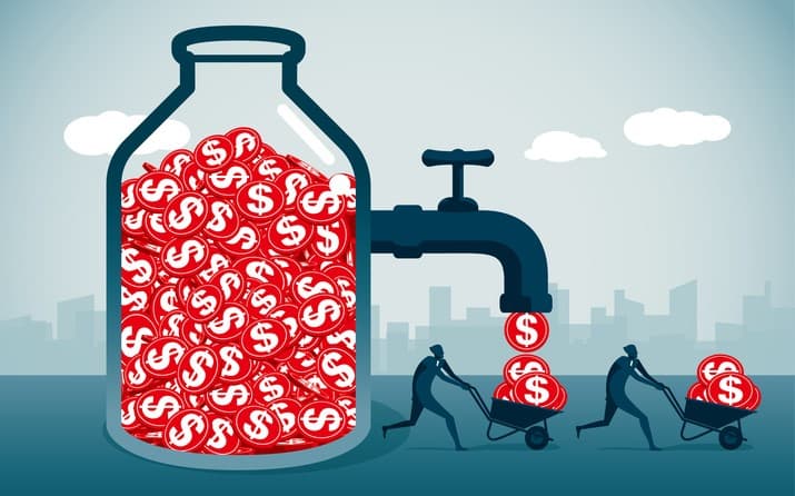 dollars in a class jar coming out of a tap