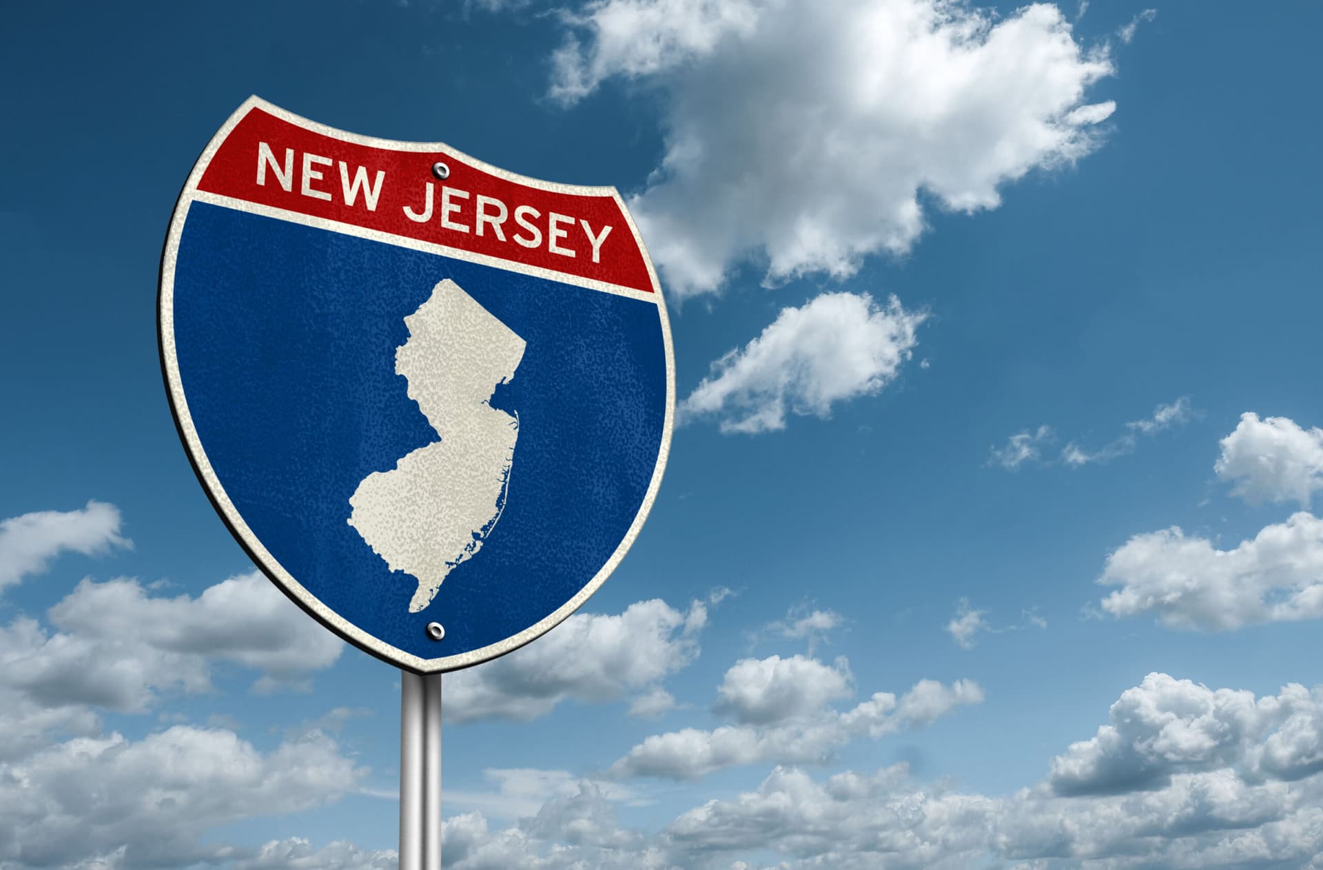An interstate sign that says "New Jersey" and has a photo of the state.