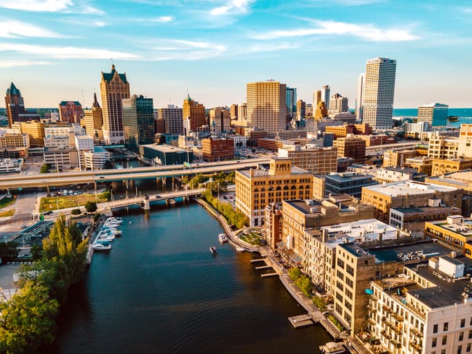 The Milwaukee skyline sits behind the view of the Milwaukee River.