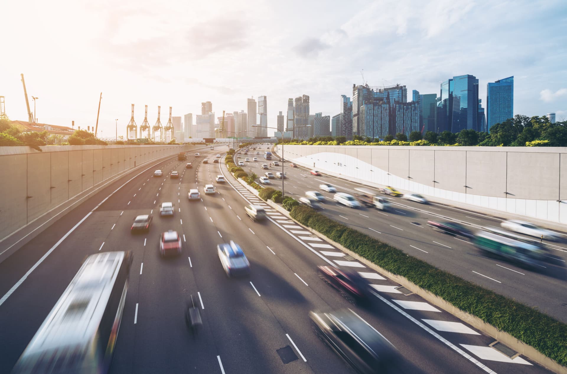 Busy road and city background during rush hour with motion-blurred vehicle, car in Singapore city highway. Modern buildings, office in background. Modern city, transportation background concept.