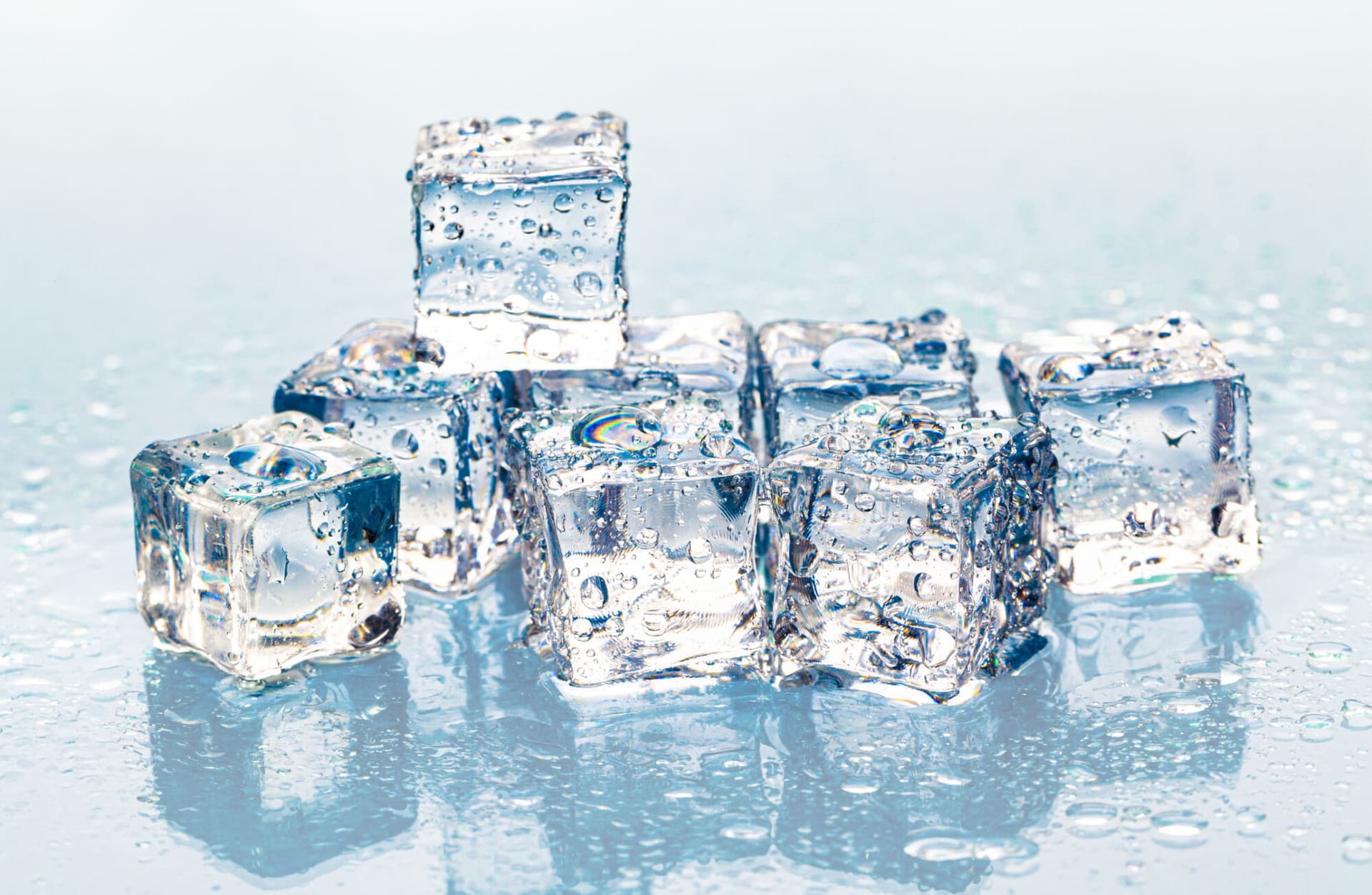 Square melting ice cubes on wet table