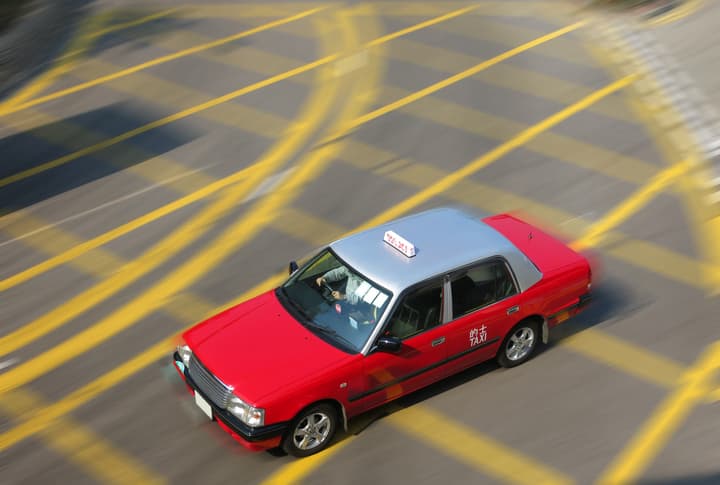 Hong Kong red taxi cab speed drive