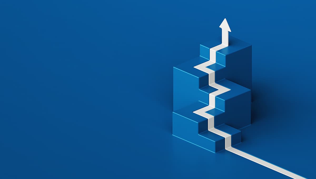 A white arrow painted on the blue floor climbs isometric steps