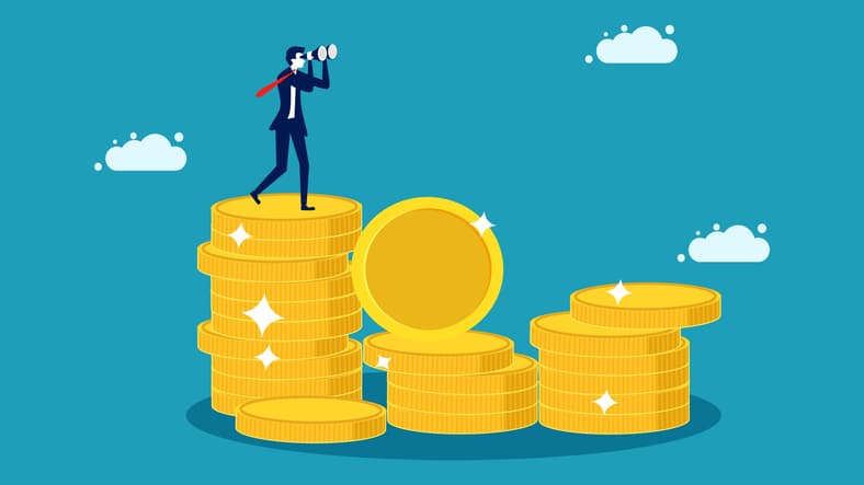 Image of a business person standing on a stack of coins.