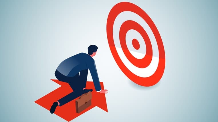 Photo of a person on an arrow that is moving toward a target.