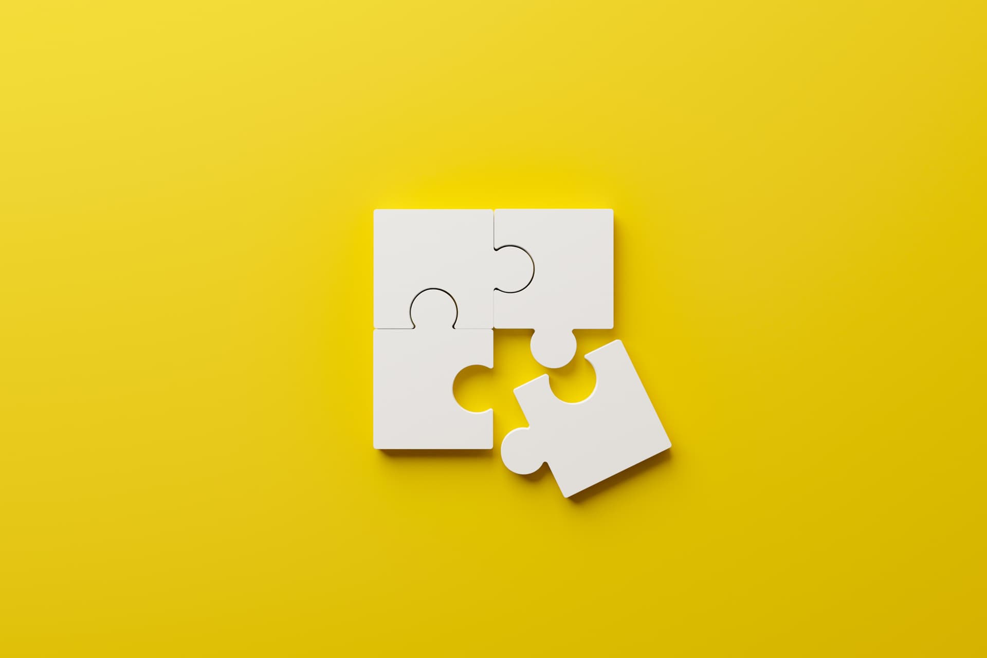 four jigsaw puzzle pieces with one misaligned