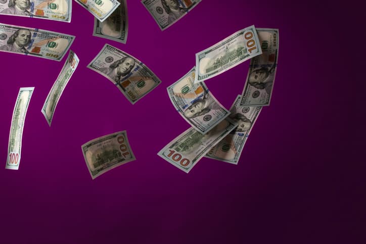 A bunch of USD $100 bills falls.